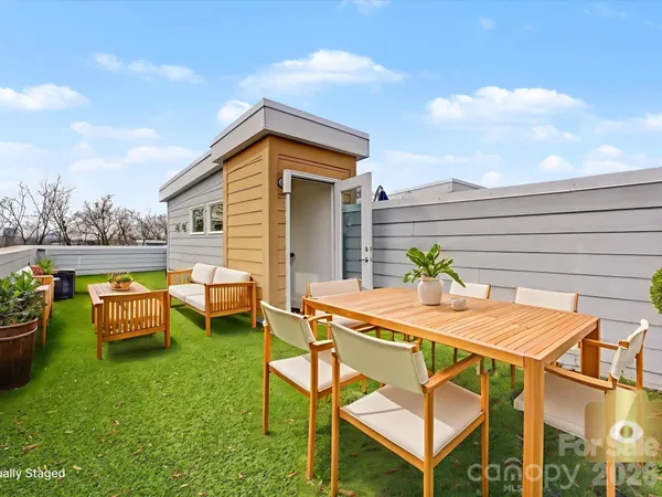 a view of a house with backyard porch and sitting area