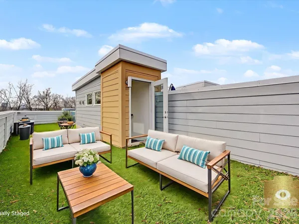 a view of a patio with couches chairs and a fire pit
