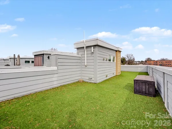 a view of a backyard with couches chairs