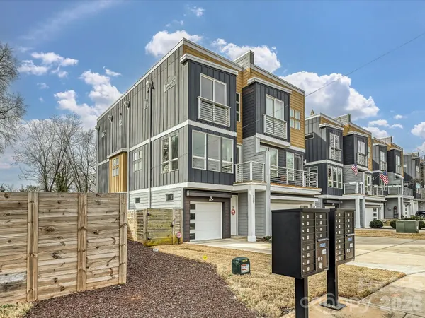a front view of a residential apartment building with a yard