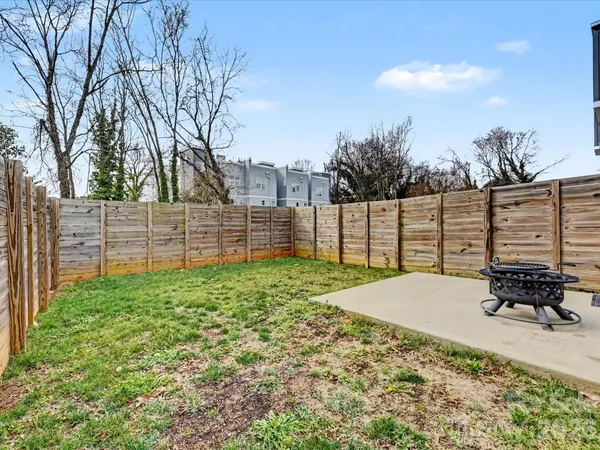 a view of a garden with wooden fence