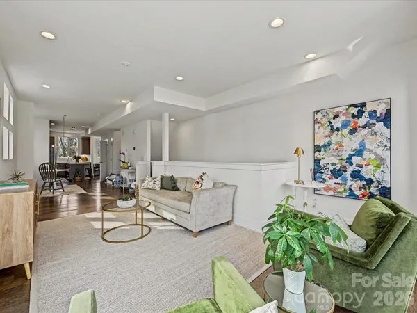 a living room with furniture and a painting