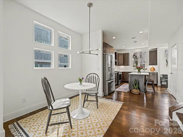 a dining room with furniture a rug and wooden floor