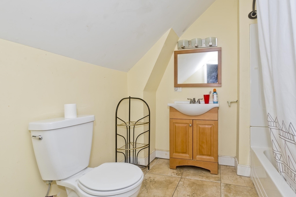 34 Temby Street Springfield, MA 01119 - Photo 11 of 22 a bathroom with a toilet a sink and mirror