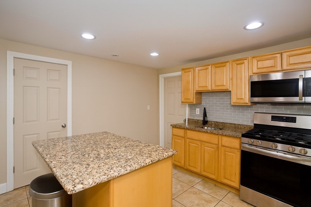 34 Temby Street Springfield, MA 01119 - Photo 3 of 22 a kitchen with stainless steel appliances granite countertop a sink stove and cabinets