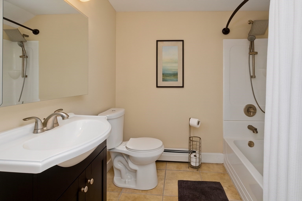 34 Temby Street Springfield, MA 01119 - Photo 8 of 22 a bathroom with a sink a toilet a mirror and shower