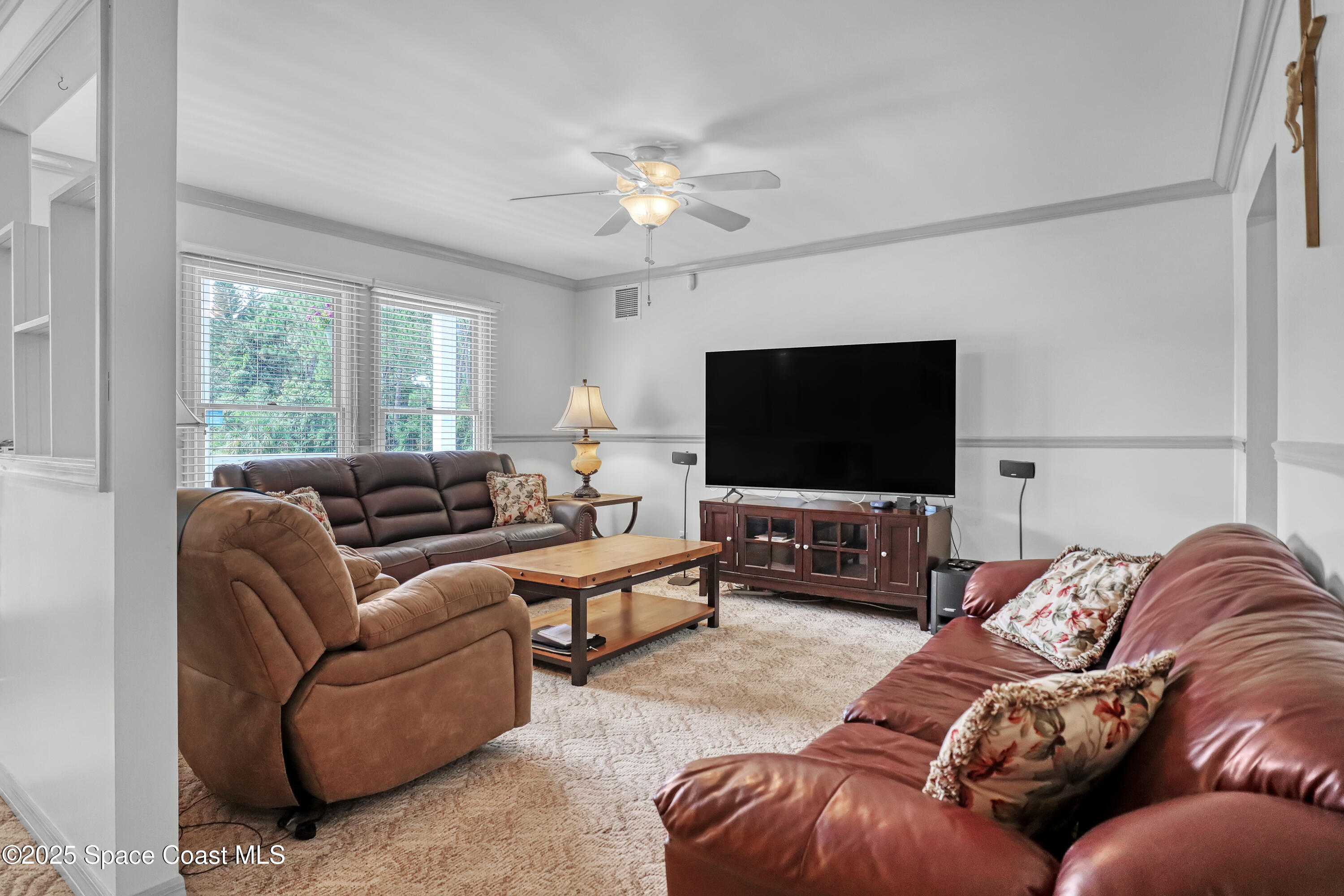 5280 Curtis Boulevard Cocoa, FL 32927 - Photo 14 of 45 a living room with furniture and a flat screen tv