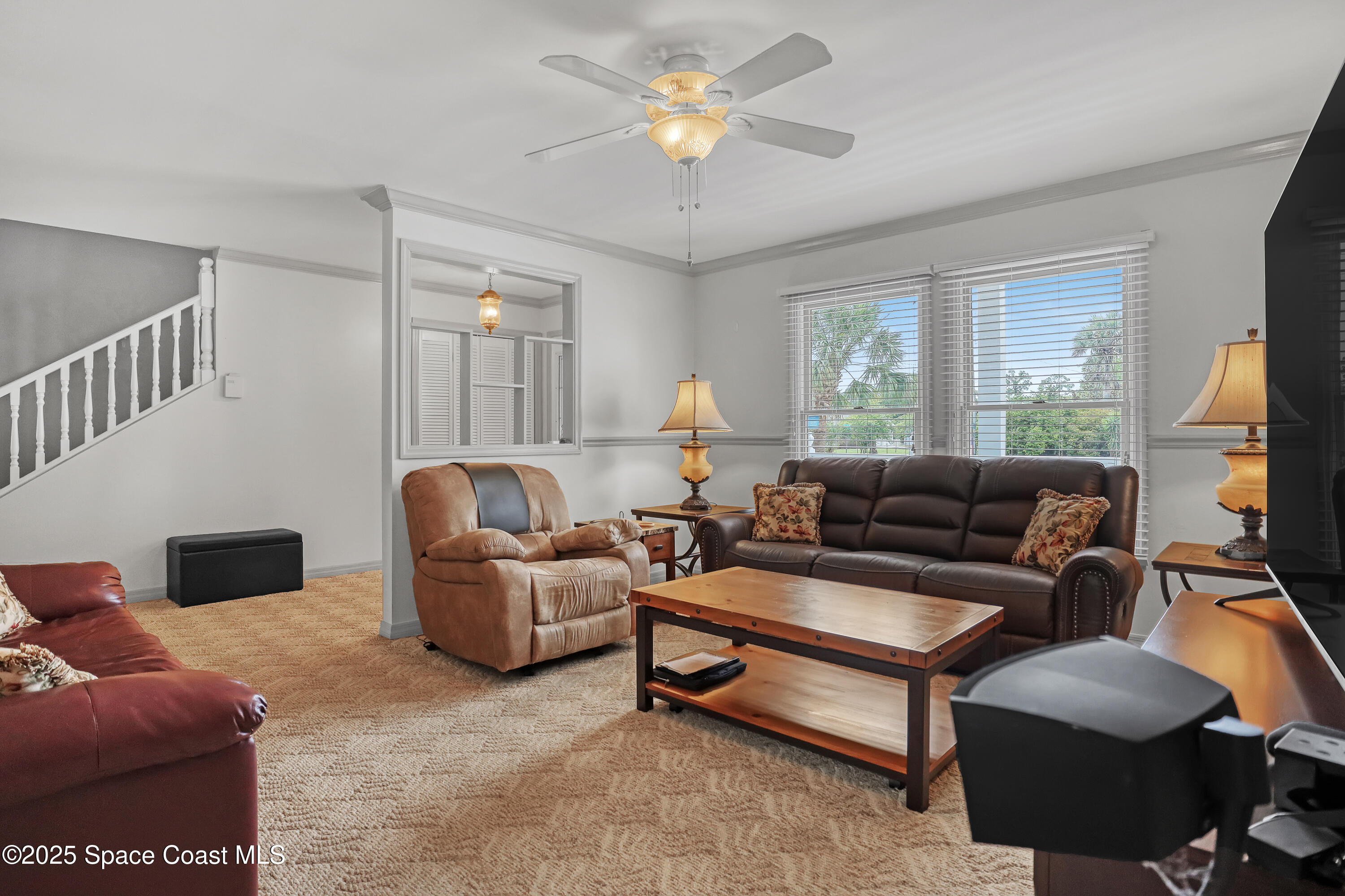 5280 Curtis Boulevard Cocoa, FL 32927 - Photo 15 of 45 a living room with furniture and a chandelier