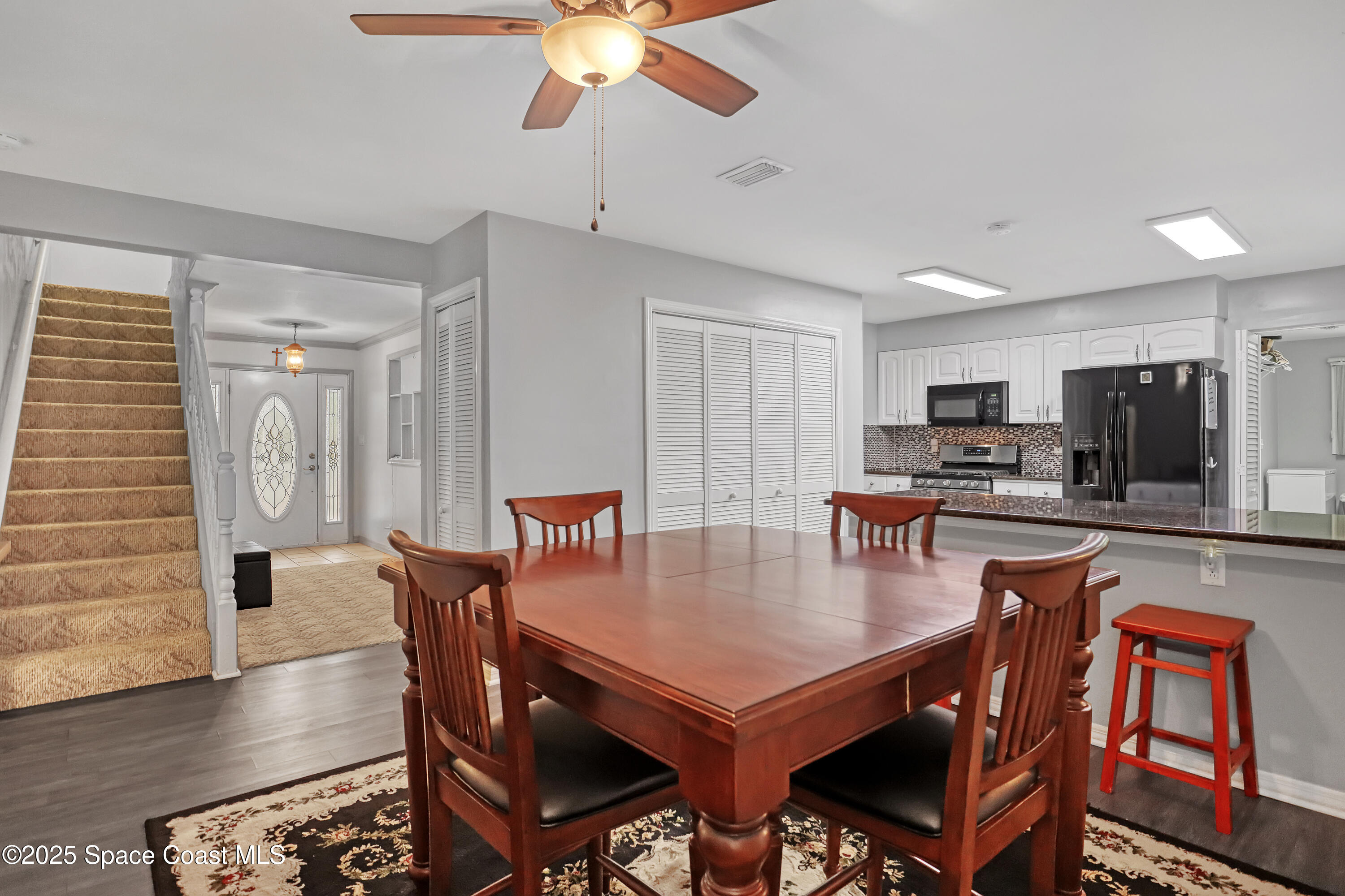 5280 Curtis Boulevard Cocoa, FL 32927 - Photo 18 of 45 a view of a dining room with furniture window and wooden floor