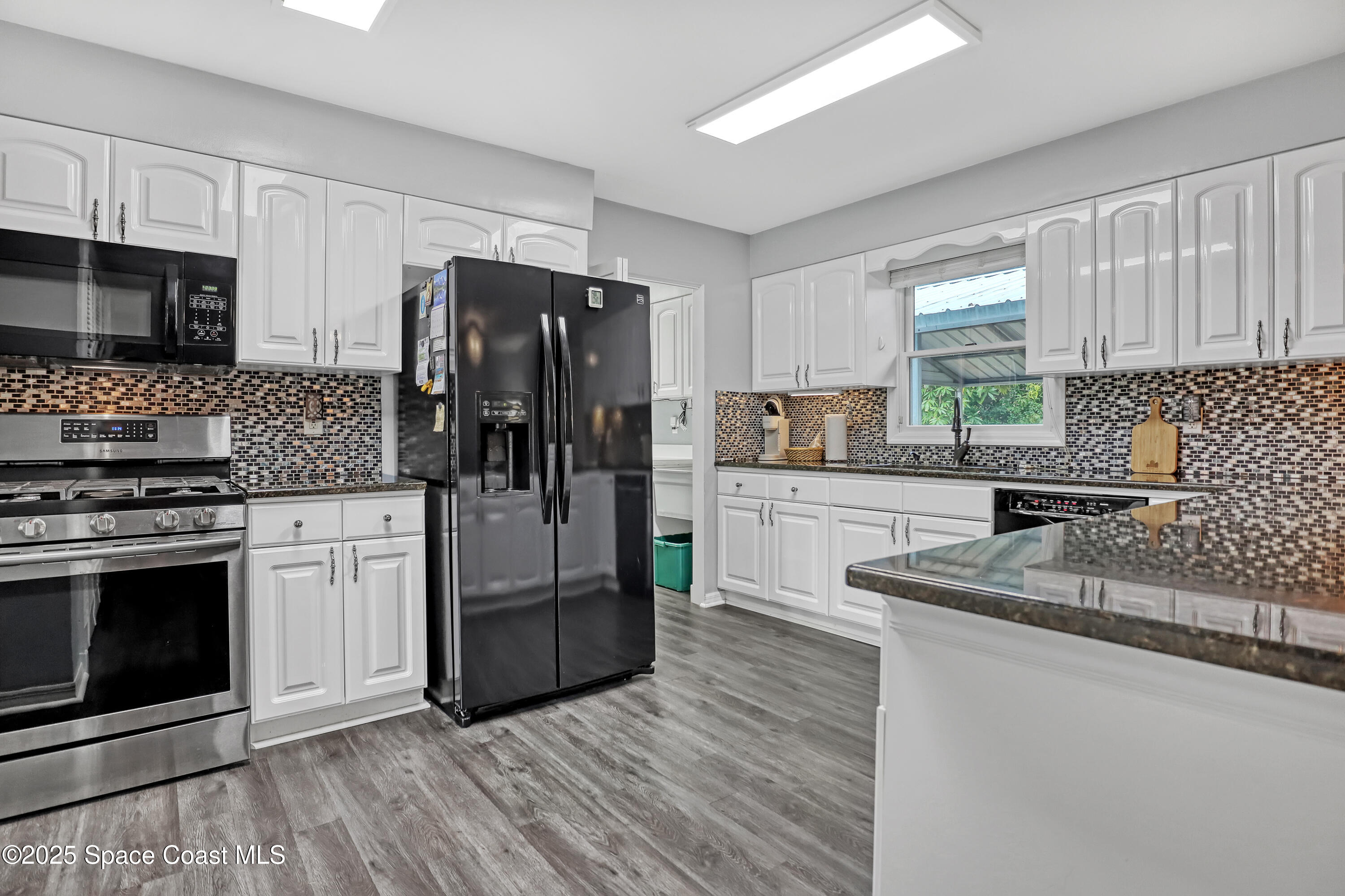 5280 Curtis Boulevard Cocoa, FL 32927 - Photo 20 of 45 a kitchen with stainless steel appliances granite countertop a refrigerator stove and sink
