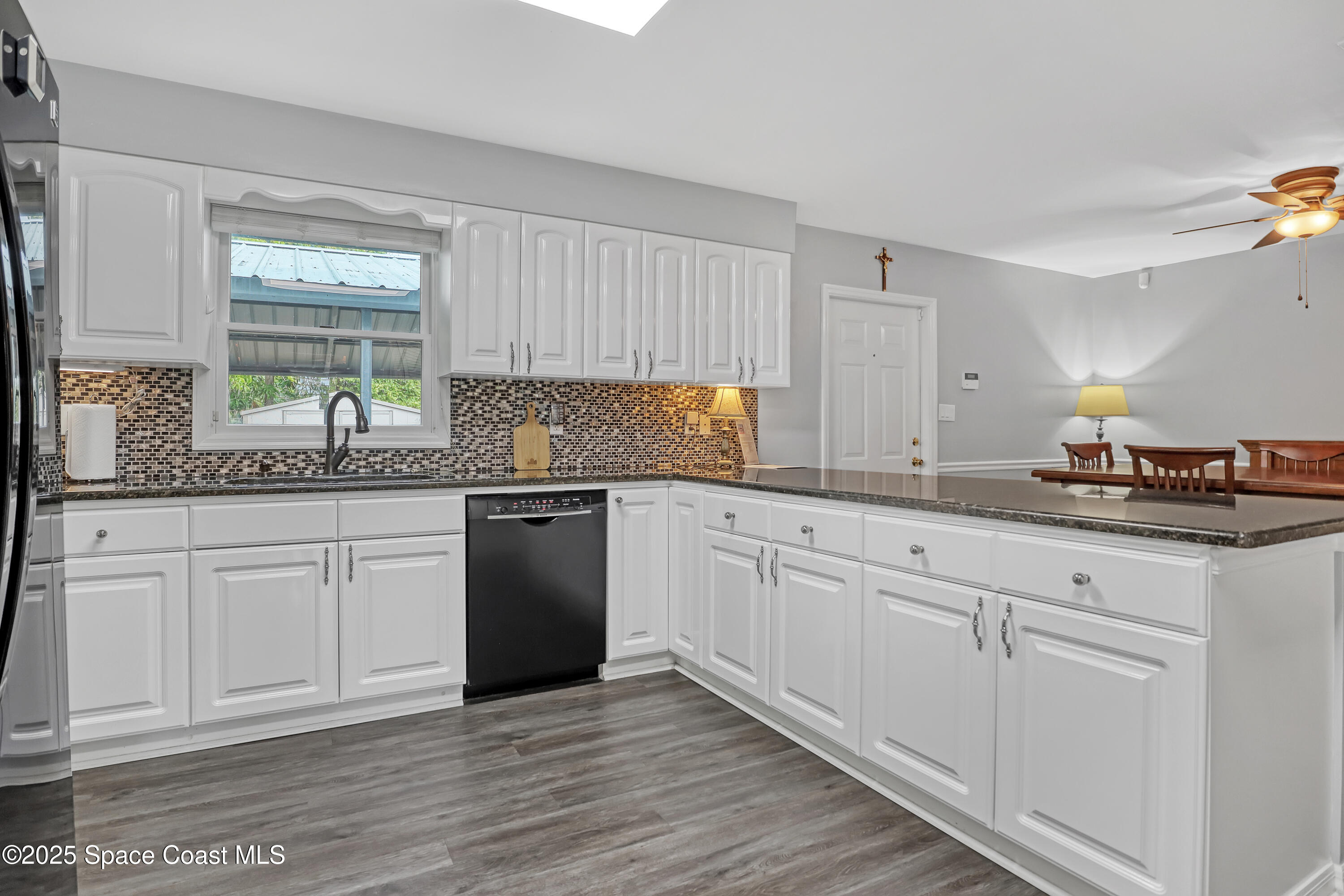 5280 Curtis Boulevard Cocoa, FL 32927 - Photo 21 of 45 a kitchen with granite countertop white cabinets and white stainless steel appliances