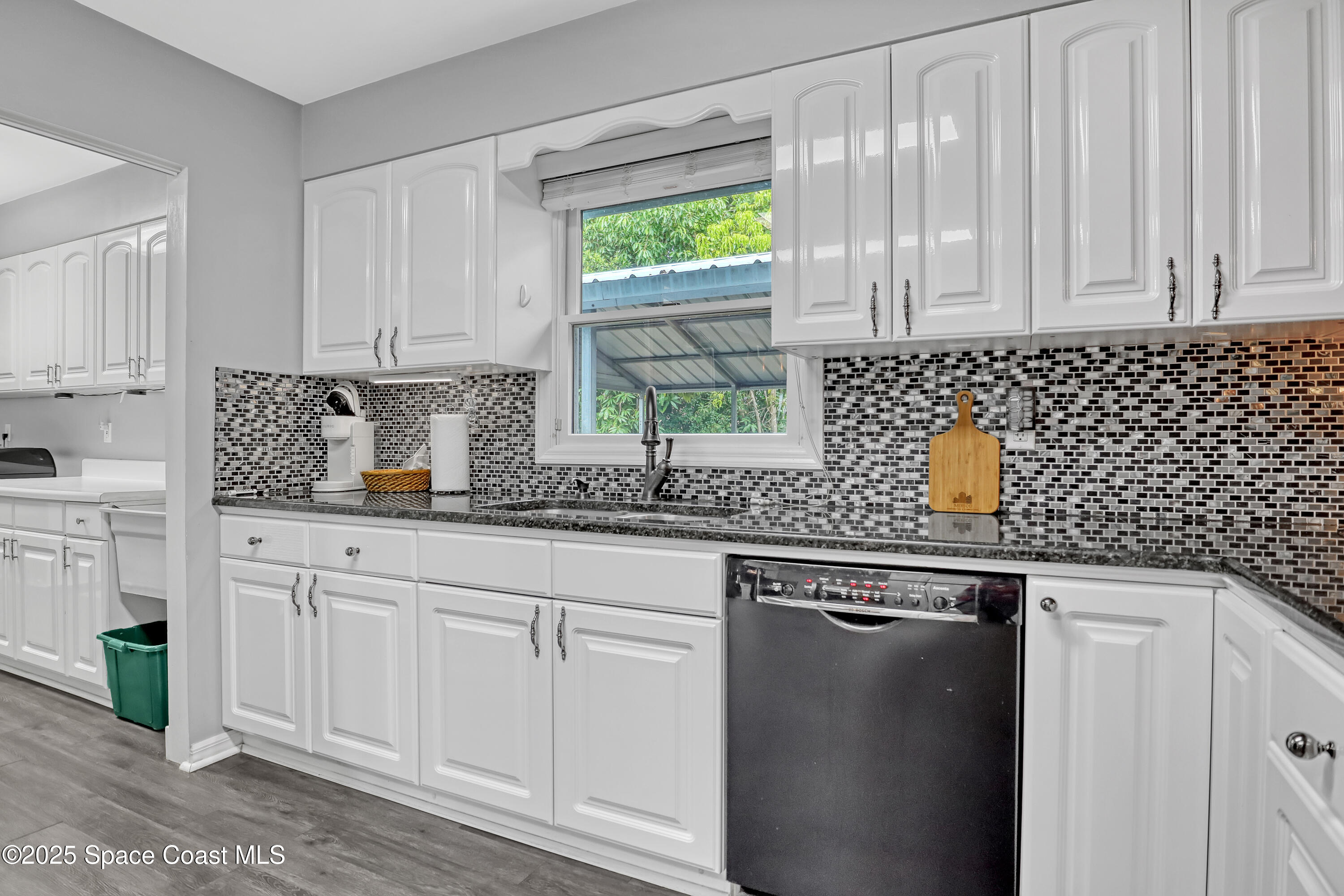 5280 Curtis Boulevard Cocoa, FL 32927 - Photo 22 of 45 a kitchen with stainless steel appliances granite countertop a sink a window and cabinets