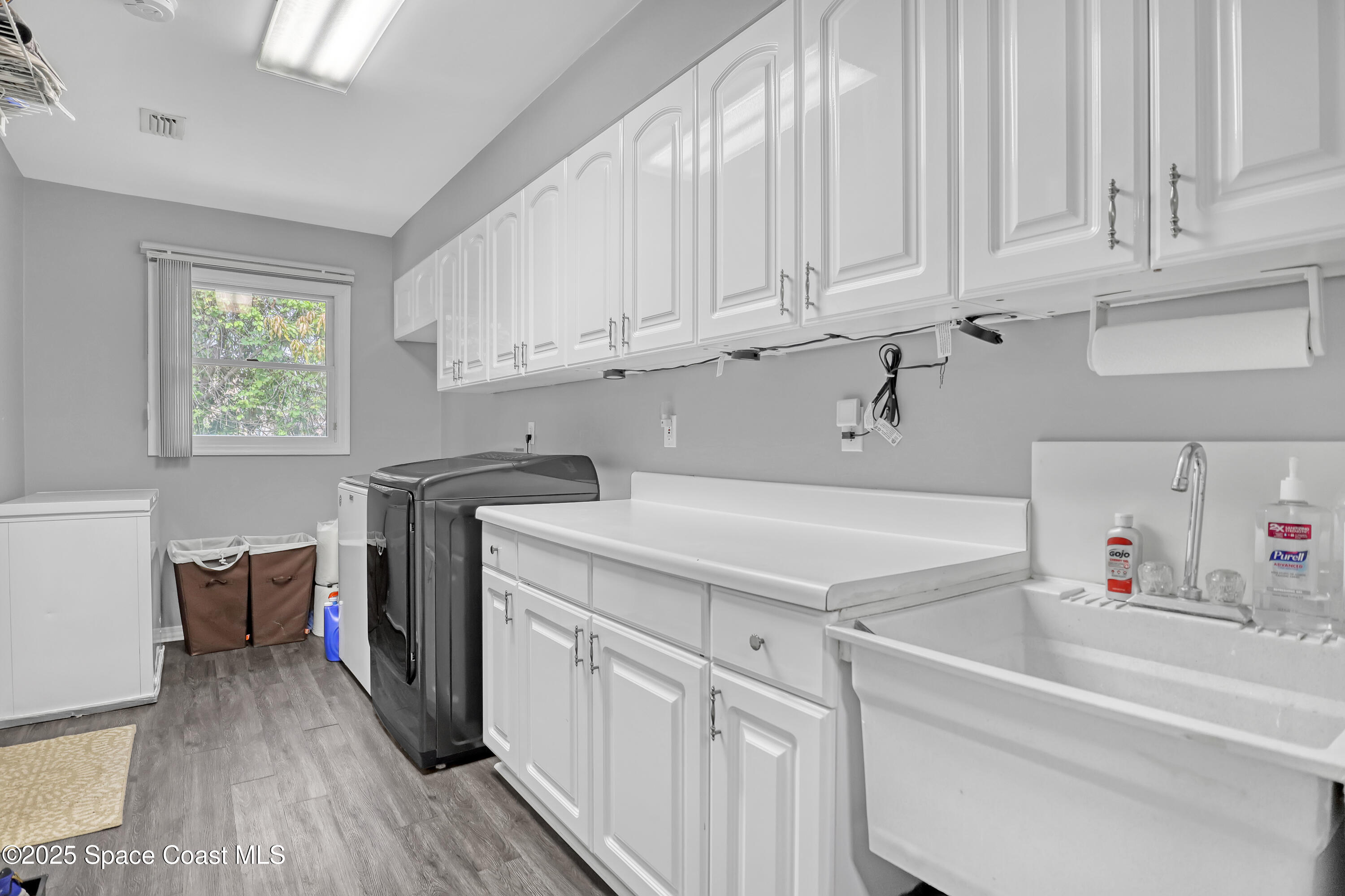 5280 Curtis Boulevard Cocoa, FL 32927 - Photo 24 of 45 a kitchen with stainless steel appliances granite countertop a sink dishwasher stove and white cabinets with wooden floor