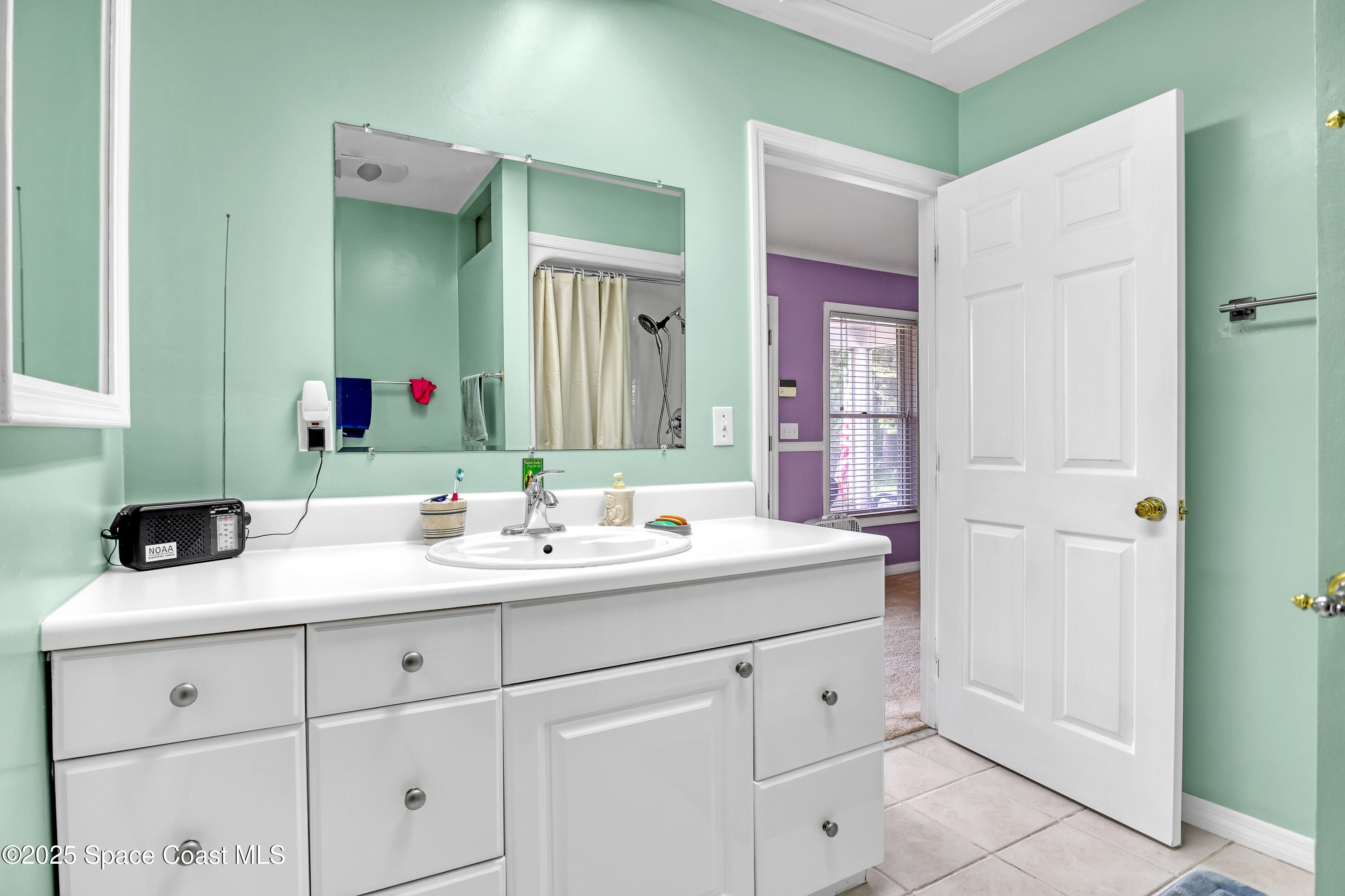 5280 Curtis Boulevard Cocoa, FL 32927 - Photo 30 of 45 a bathroom with a sink and a mirror