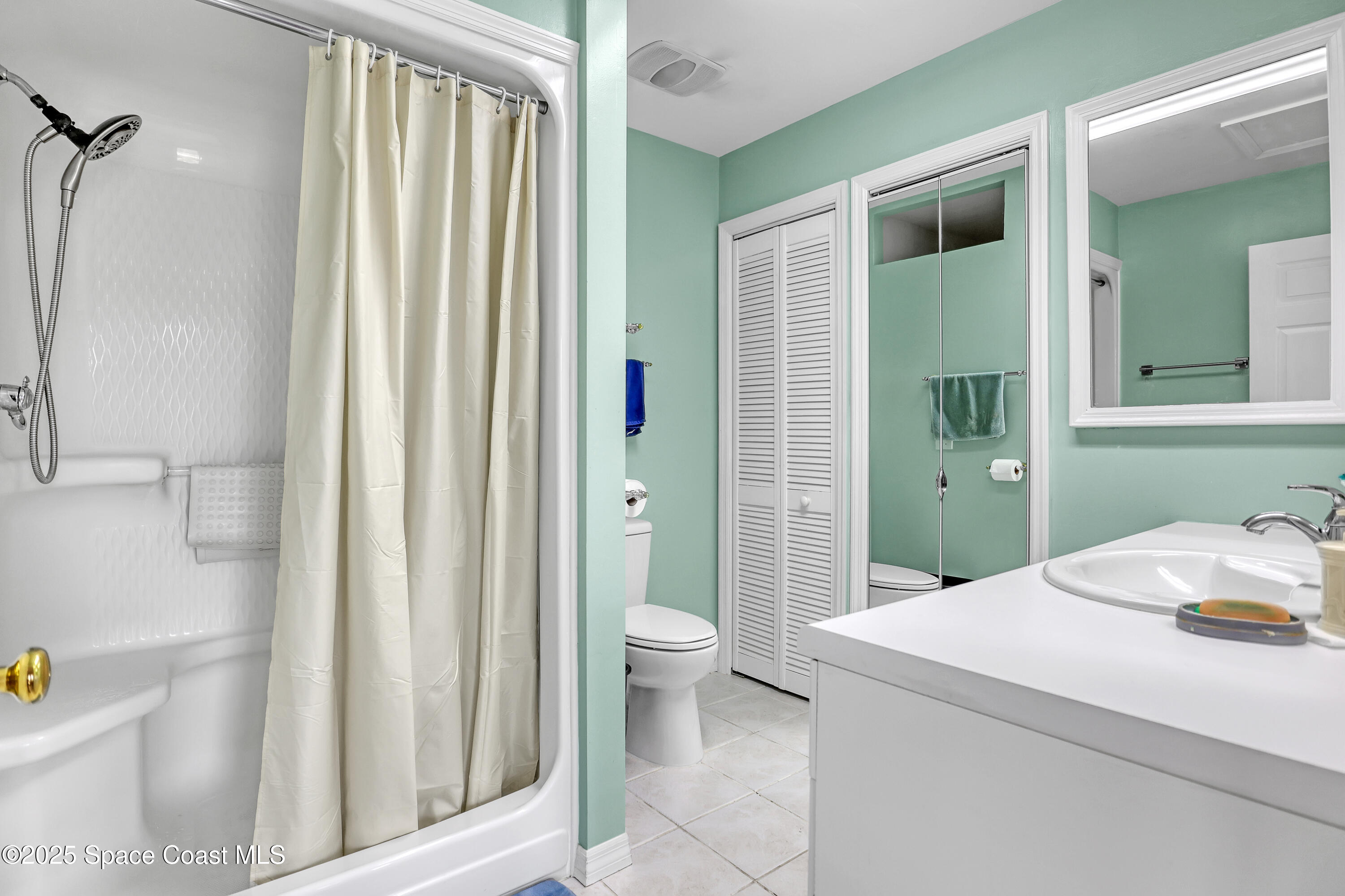 5280 Curtis Boulevard Cocoa, FL 32927 - Photo 31 of 45 a bathroom with a sink and a mirror