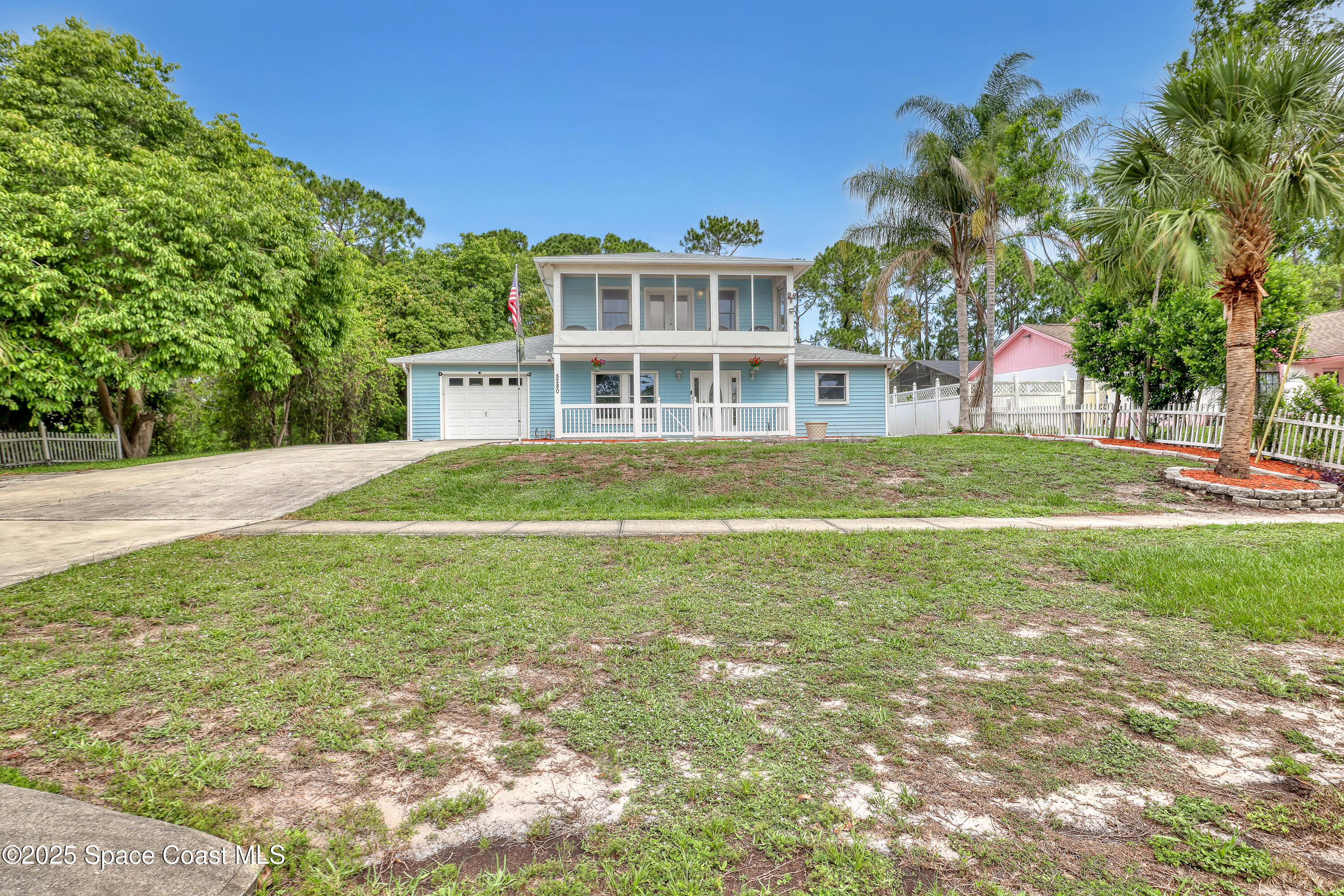 5280 Curtis Boulevard Cocoa, FL 32927 - Photo 6 of 45 a front view of a house with a big yard