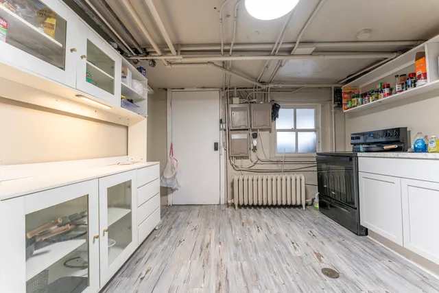 a kitchen with cabinets and wooden floor