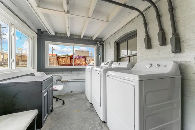 a utility room with dryer washer and a window