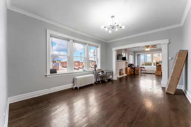a spacious bedroom with furniture and a large window