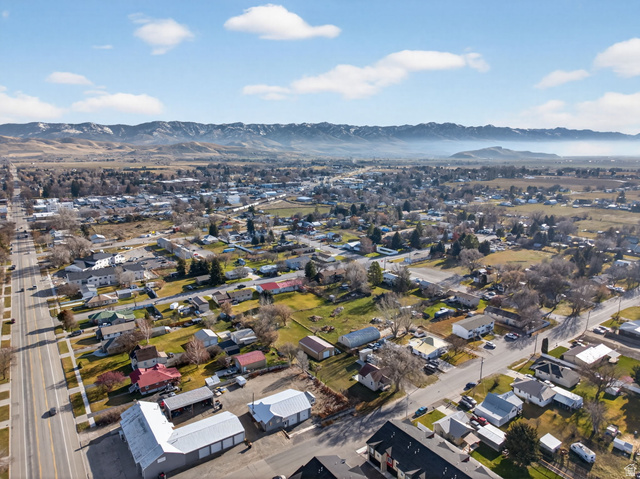 49 South 4th W Street Preston, ID 83263 - Photo 44 of 48 Aerial overview of property's location with a mountain backdrop and nearby suburban area