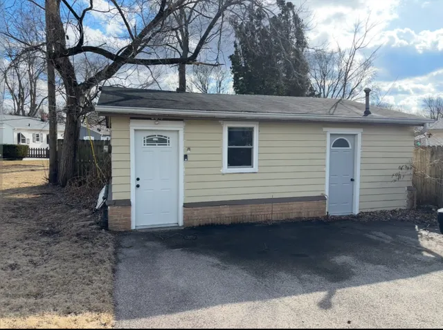 a view of a house with a space and a tree
