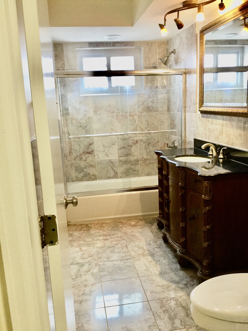 2016 Maple Avenue Northbrook, IL 60062 - Photo 14 of 32 a bathroom with a granite countertop sink toilet and shower