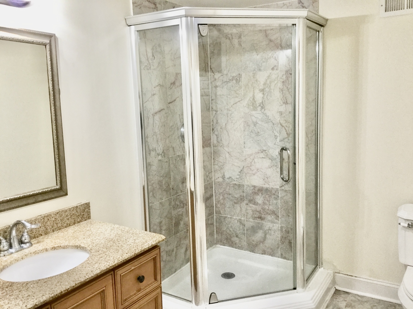 2016 Maple Avenue Northbrook, IL 60062 - Photo 15 of 32 a bathroom with a granite countertop sink mirror and shower