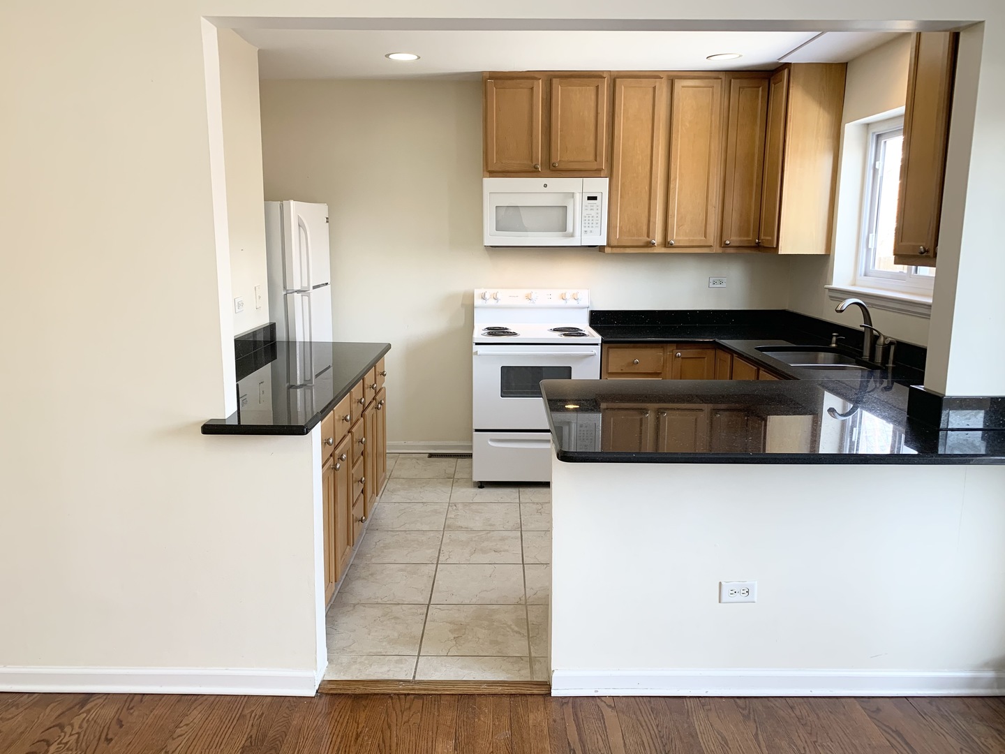 2016 Maple Avenue Northbrook, IL 60062 - Photo 9 of 32 a kitchen with stainless steel appliances granite countertop a stove a sink and a microwave