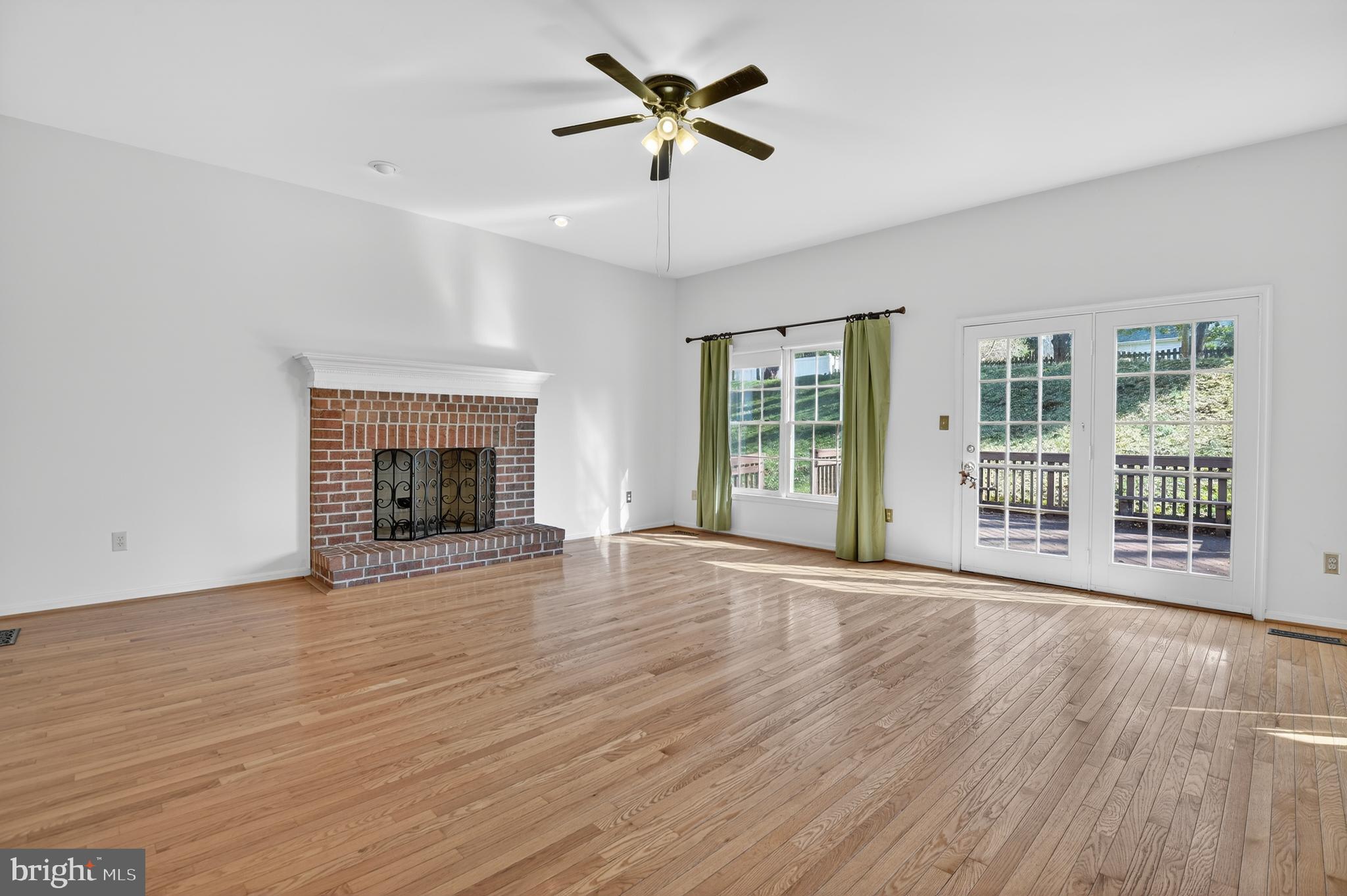 13106 Quail Creek Court Silver Spring, MD 20904 - Photo 12 of 43 wooden floor fireplace and windows in an empty room