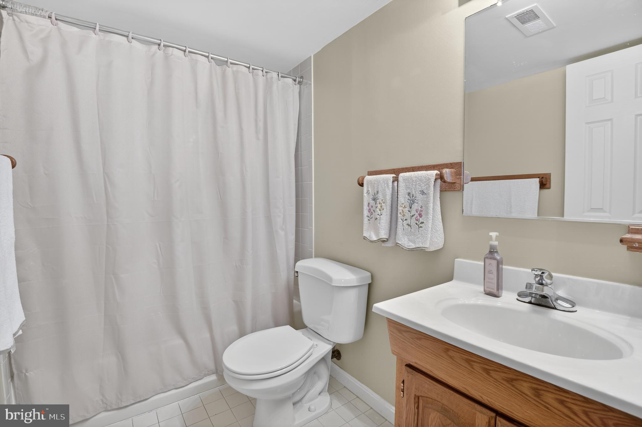 13106 Quail Creek Court Silver Spring, MD 20904 - Photo 38 of 43 a bathroom with a sink toilet and a mirror