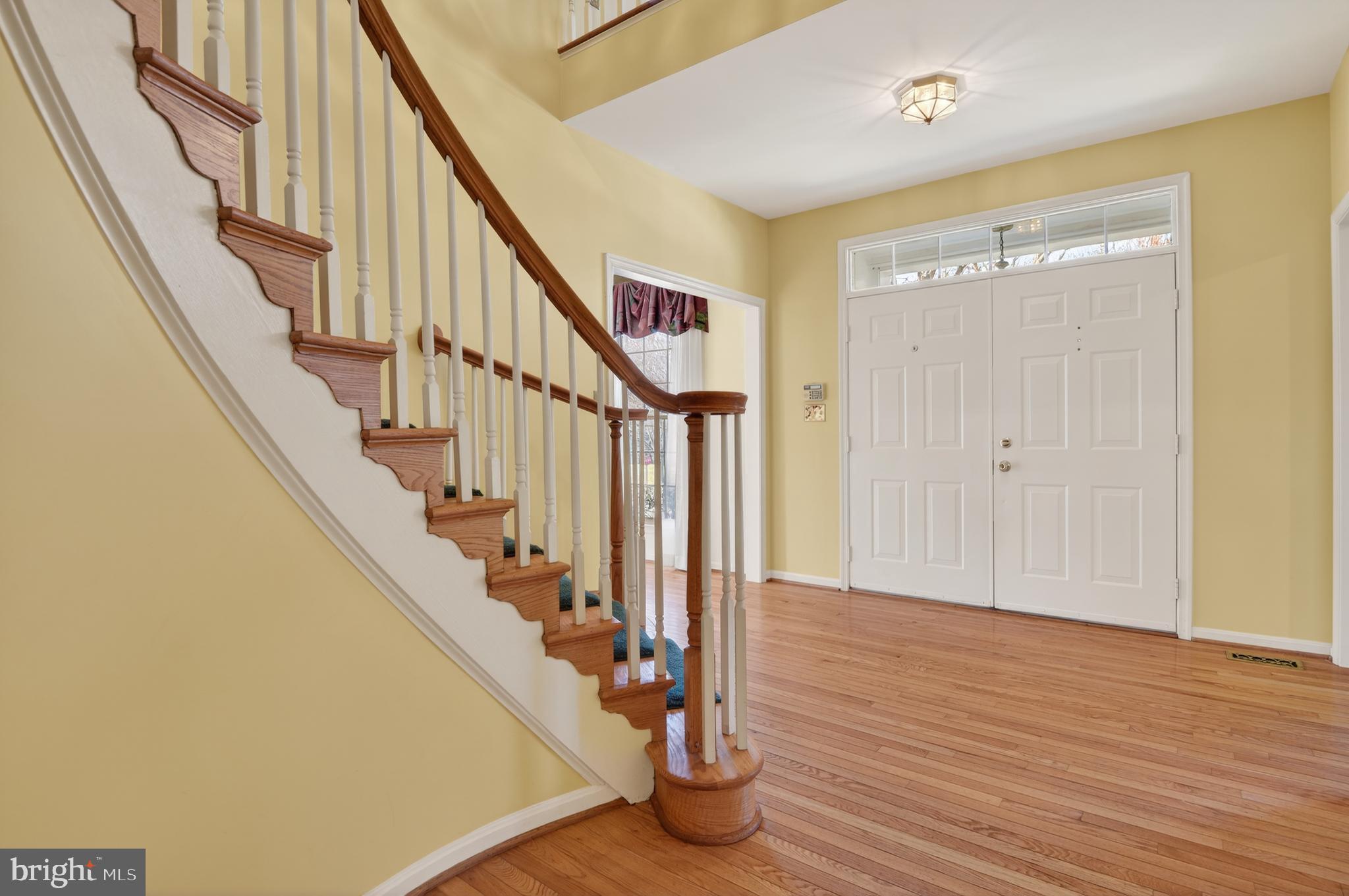 13106 Quail Creek Court Silver Spring, MD 20904 - Photo 6 of 43 a view of entryway with wooden floor and stairs