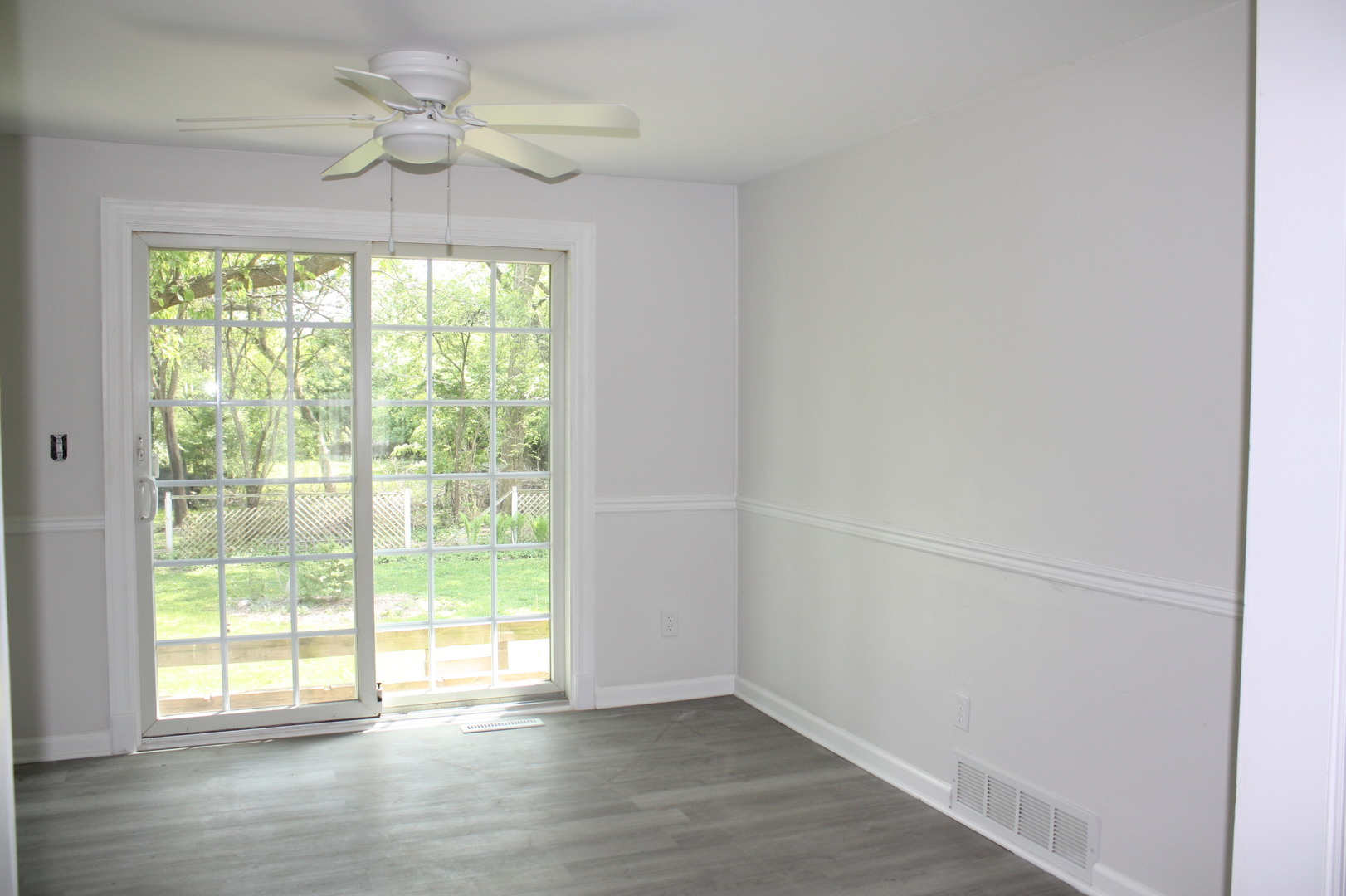 345 Souwanas Trail Algonquin, IL 60102 - Photo 5 of 16 an empty room with wooden floor chandelier fan and windows