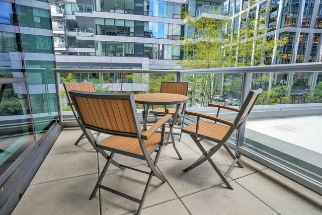 a view of a chairs and table in the balcony