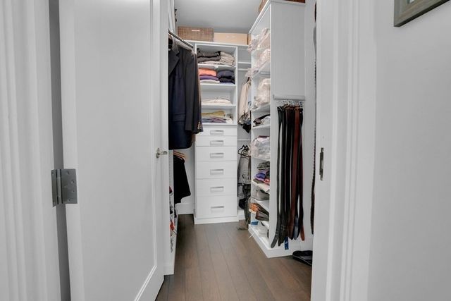 a view of walk in closet with clothes