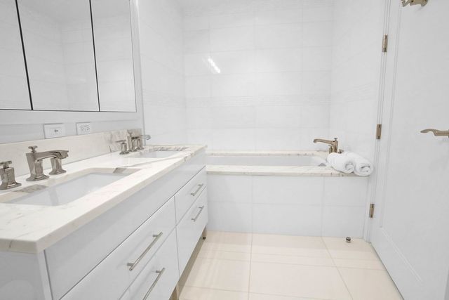 a bathroom with a sink vanity and a mirror