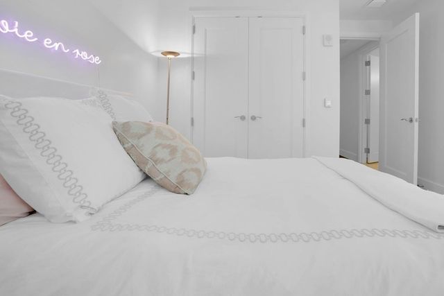 a bedroom with a bed and a night stand