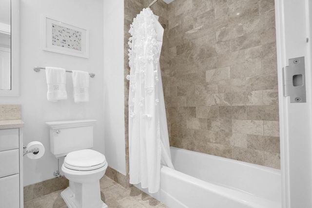 a bathroom with a toilet and a bathtub