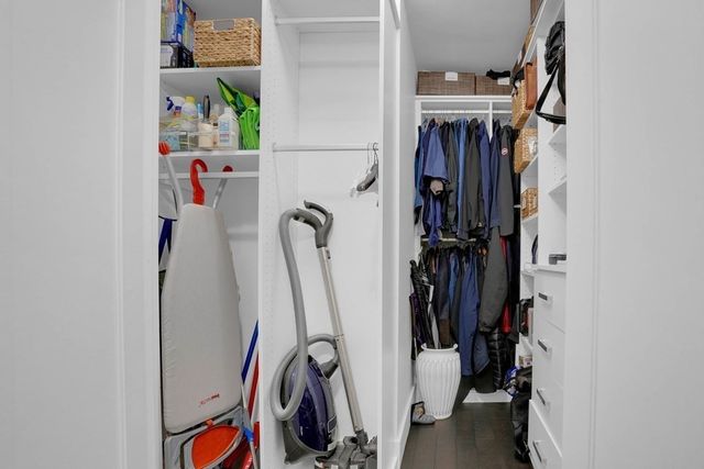 a view of walk in closet with clothes and shoes