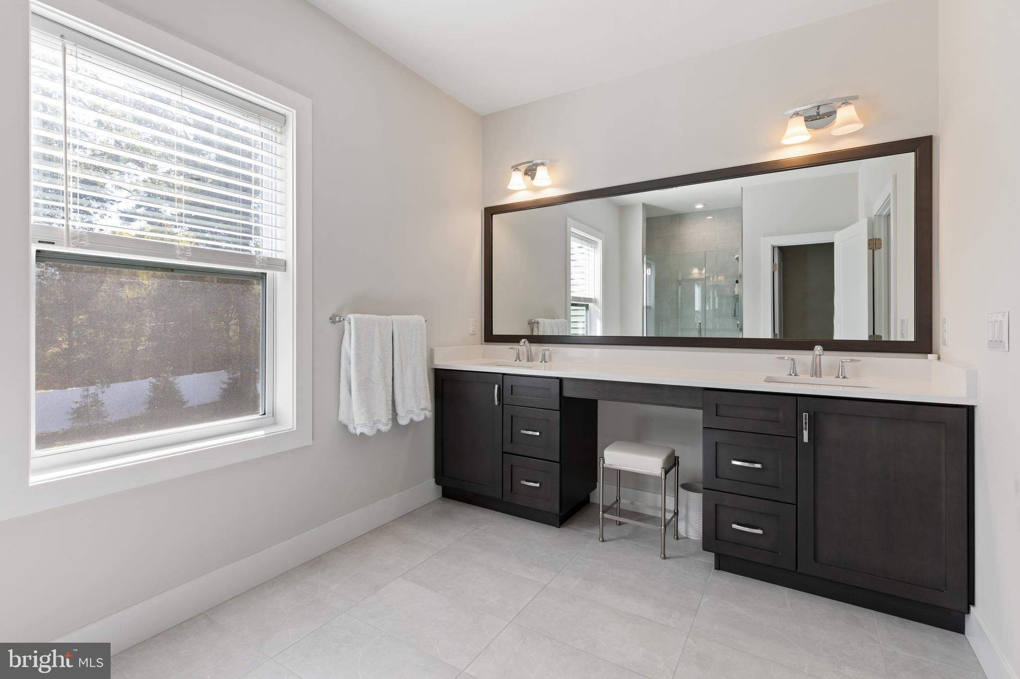 662 Levering Street Blue Bell, PA 19422 - Photo 14 of 31 a bathroom with a double vanity sink and a mirror