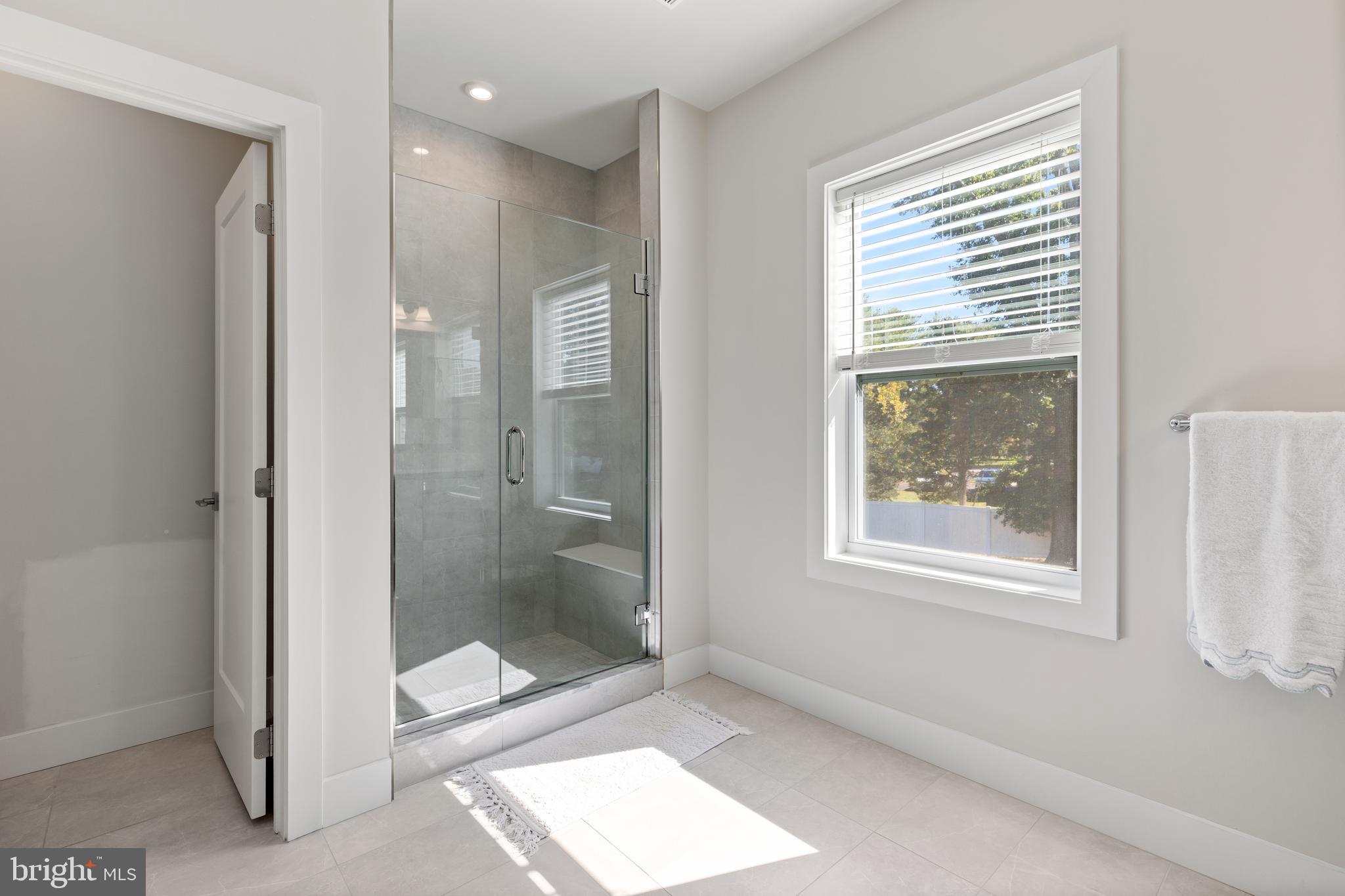 662 Levering Street Blue Bell, PA 19422 - Photo 15 of 31 a bathroom with a glass shower door and a window