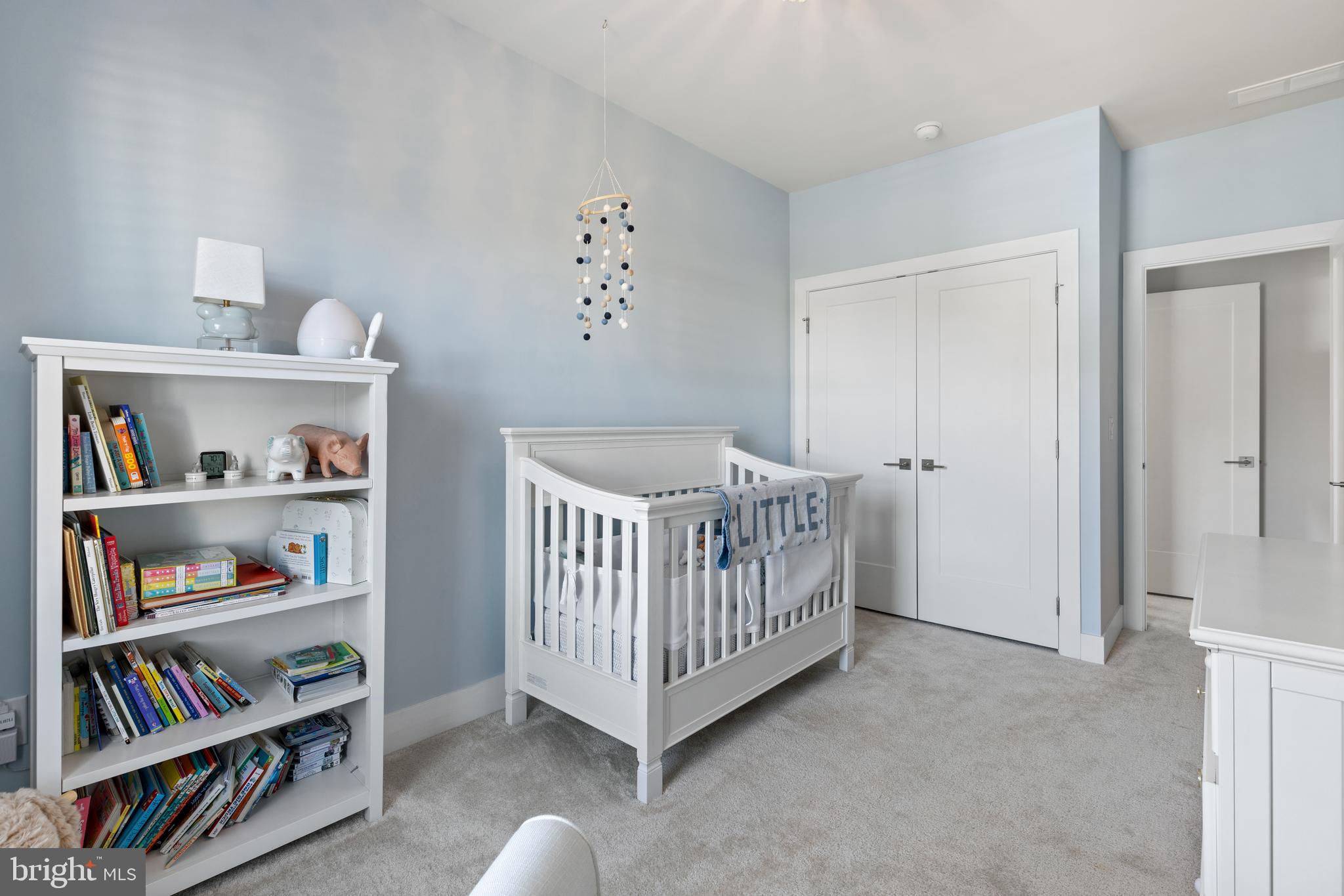 662 Levering Street Blue Bell, PA 19422 - Photo 19 of 31 a view of a bedroom with baby crib and book shelf