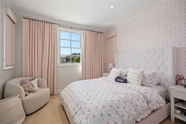 a bedroom with a bed couch and a window