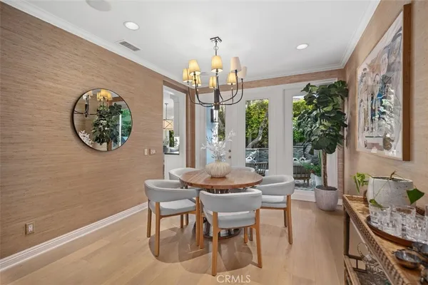 a living room with furniture kitchen view and a large window