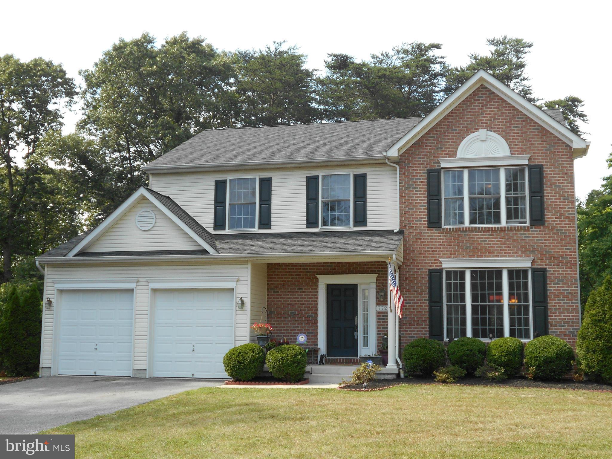 7726 Locust Wood Road Severn, MD 21144 - Photo 1 of 23 a front view of a house with garden