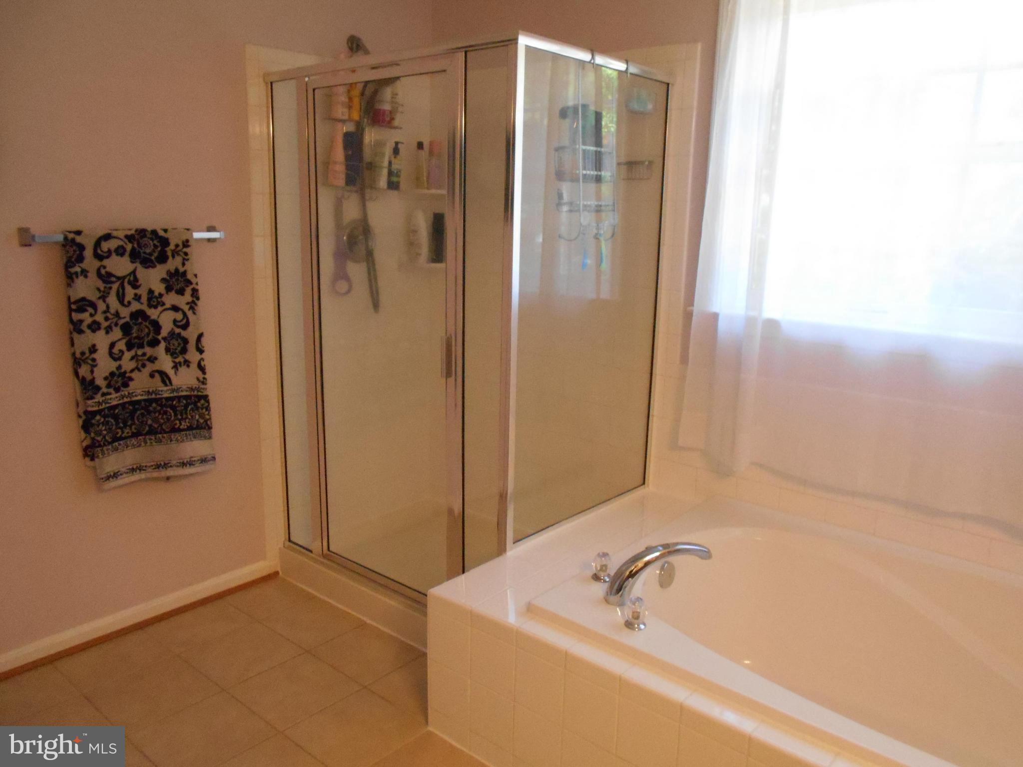 7726 Locust Wood Road Severn, MD 21144 - Photo 14 of 23 a bathroom with a shower and a tub