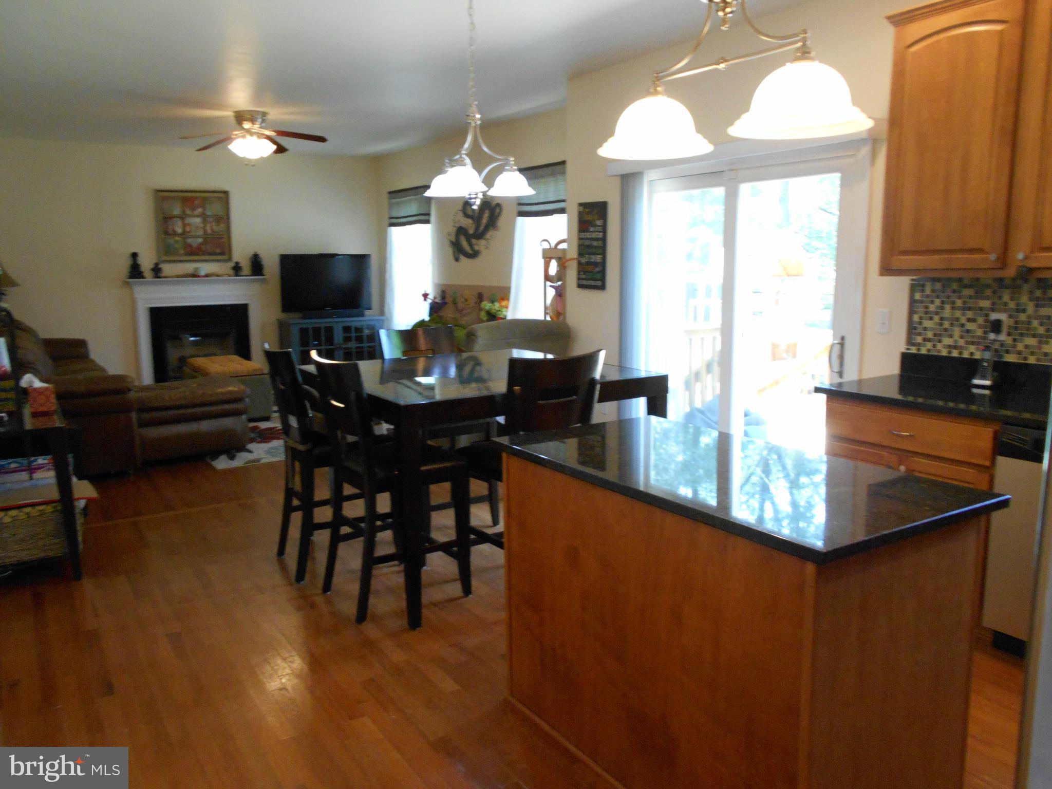 7726 Locust Wood Road Severn, MD 21144 - Photo 4 of 23 a view of a dining room with furniture window and wooden floor