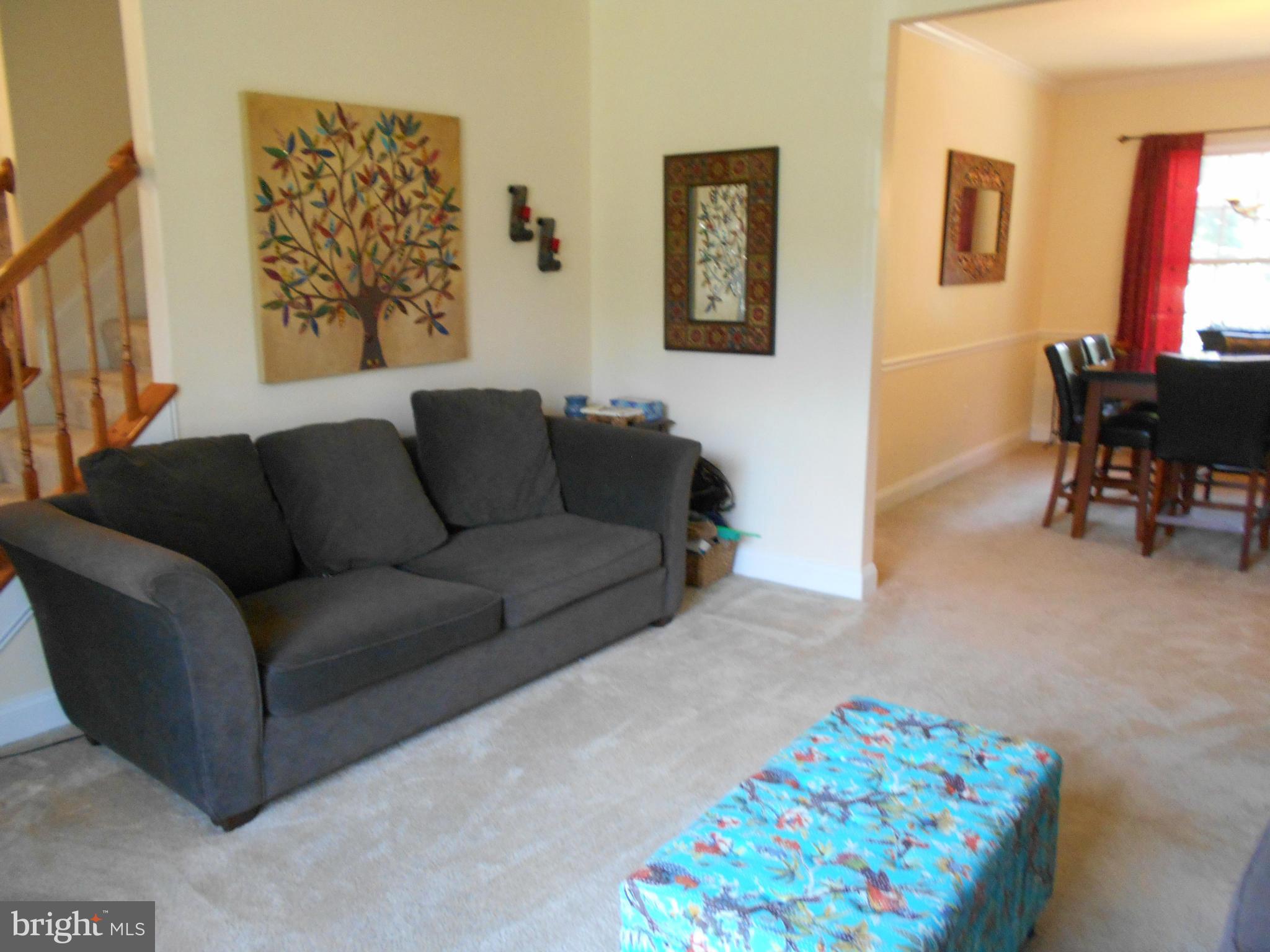 7726 Locust Wood Road Severn, MD 21144 - Photo 7 of 23 a living room with furniture and a couch