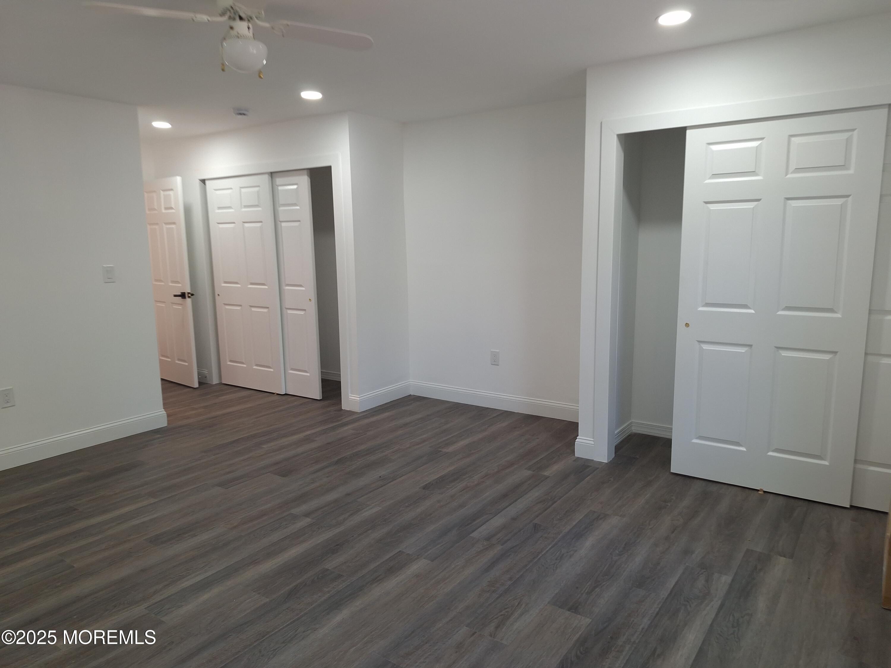 414 Oak Tree Road Freehold, NJ 07728 - Photo 14 of 25 an empty room with wooden floor and windows