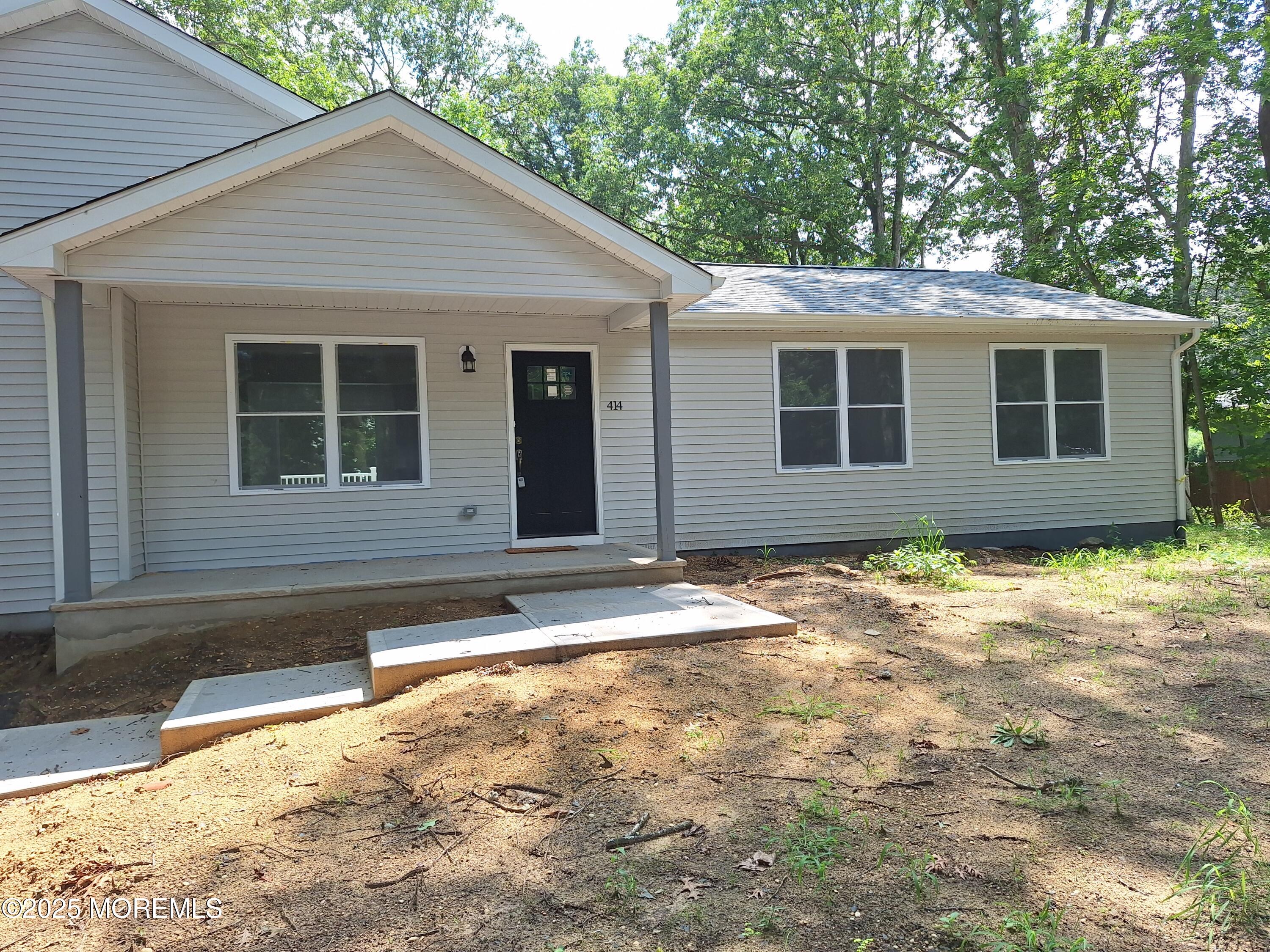 414 Oak Tree Road Freehold, NJ 07728 - Photo 3 of 25 a house with trees in the background