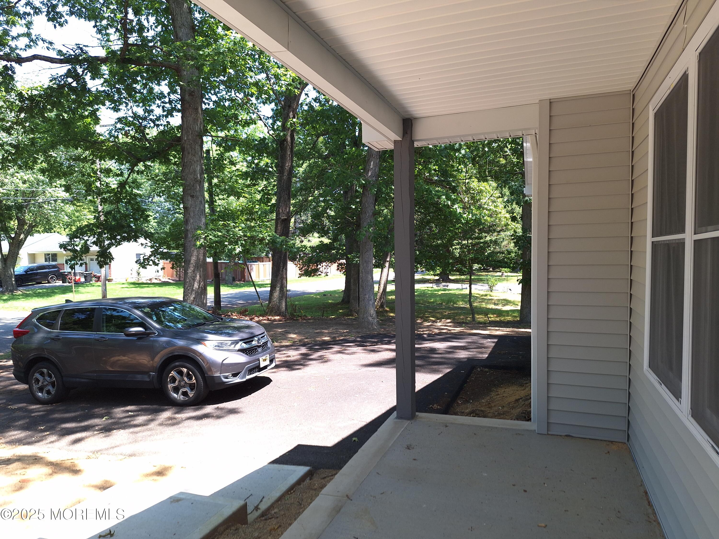 414 Oak Tree Road Freehold, NJ 07728 - Photo 4 of 25 a view of a yard with car parked